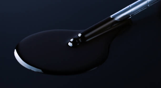 istock Pipette and oil on black background 1288992790