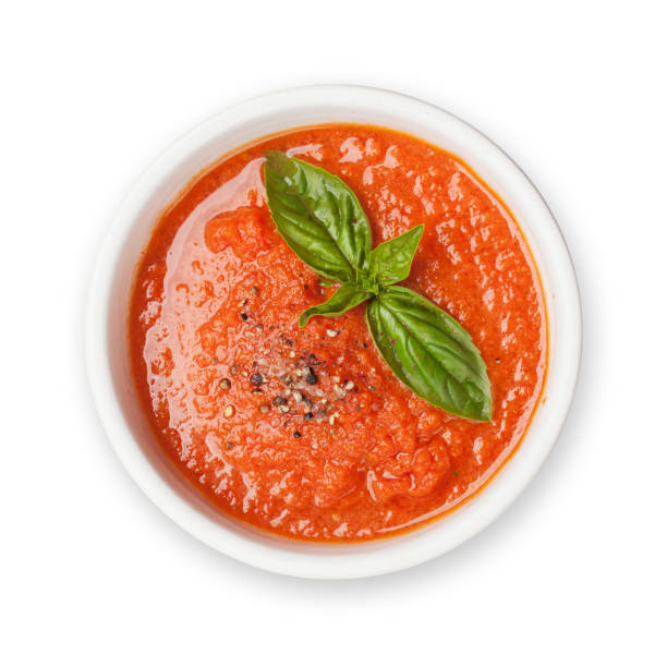 Cold gazpacho soup Cold gazpacho soup with ripe tomatoes, cucumber and basil. Isolated on white background. Top view flat lay tomato soup stock pictures, royalty-free photos & images
