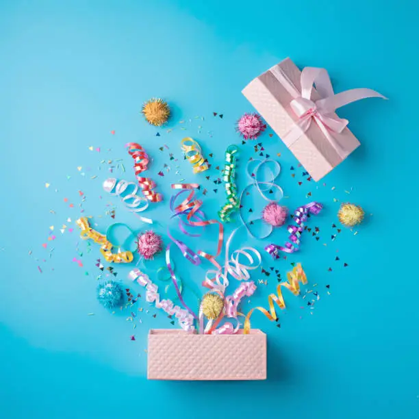 Photo of Creative layout with Christmas confetti on light blue background