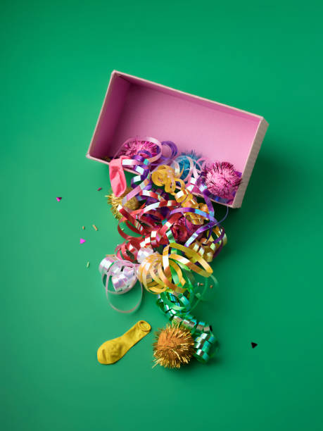 istock Opened traditional Christmas gift box with confetti on green background 1288994431