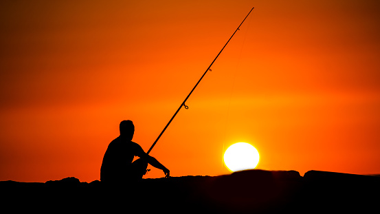 A fisherman uses a fishing rod