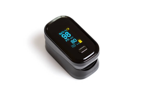 Pulse oximeter on white background with data of blood oxygen saturation and pulse. Pulse oximeter on white background. In measure blood oxygen saturation and pulse. saturated color stock pictures, royalty-free photos & images