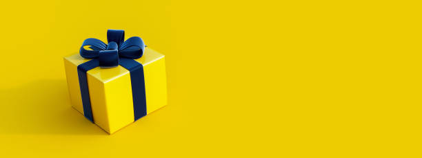 istock Yellow gift box with elegant dark bow on yellow background 1288995790