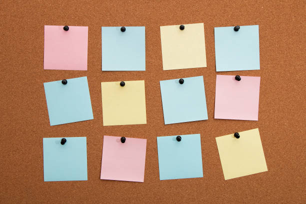 istock Multicolored paper stickers on cork board 1288996292