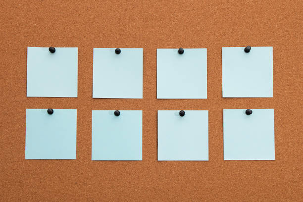 istock Multicolored paper stickers on cork board 1288996294