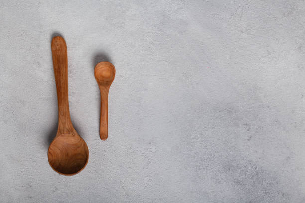 istock Wooden spoons on a light background 1288996395