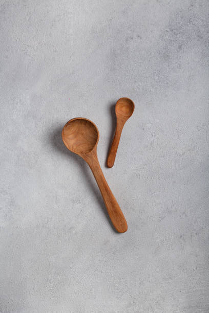 istock Wooden spoons on a light background 1288996465