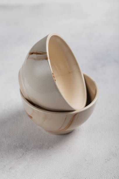istock Two white clay bowls on a light background 1288997060