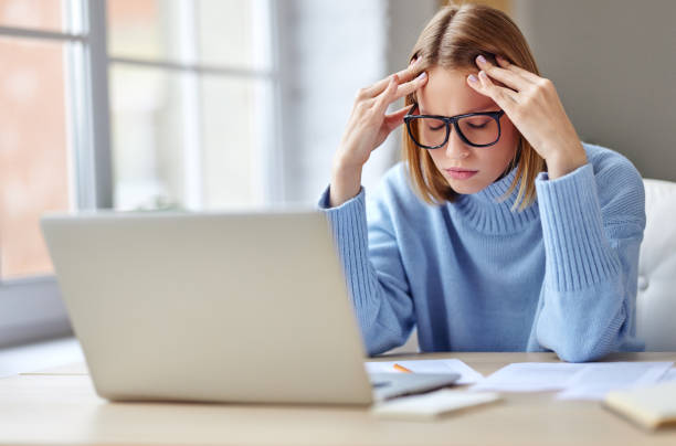 istock Tired female freelancer working at home 1288997340