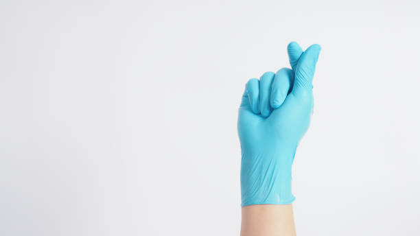 istock Male model's hand with glove is doing mini heart hand sign on white background. 1288997369