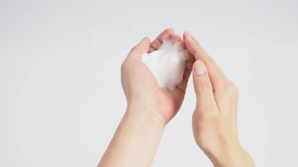 istock Hands washing gesture with foaming hand soap on white background. 1288997522
