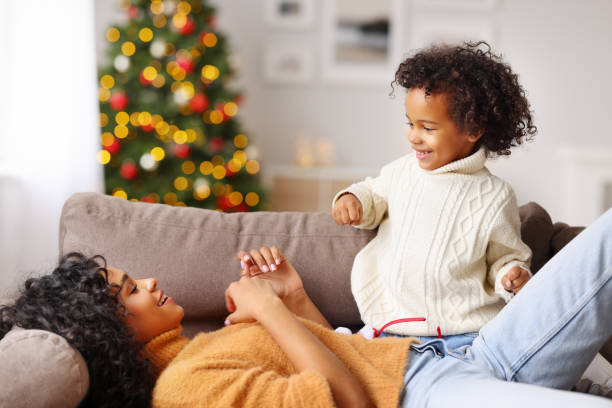 istock Mother and son playing on sofa on Christmas day 1288998002