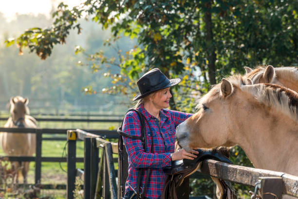 istock Woman and her horses 1288999370