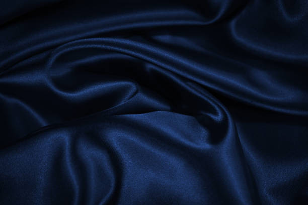 istock Dark blue elegant background. Crumpled satin texture background. The surface of a dark blue shiny fabric with nice folds. 1288999687