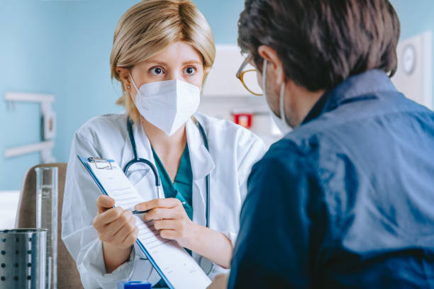 istock Doctor and patient sitting in doctor's office 1288999713
