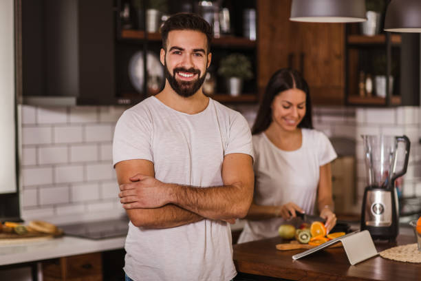 istock Couple making fresh organic juice in kitchen together 1289000395