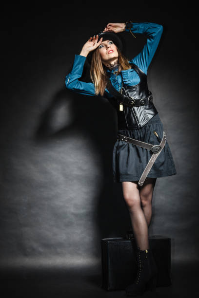 istock beautiful steampunk woman with bag on black. 1289000498