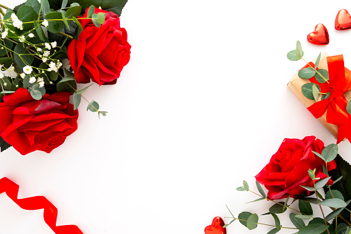 Roses and eucalyptus on white background. Valentine's Day concept, copy space for text
