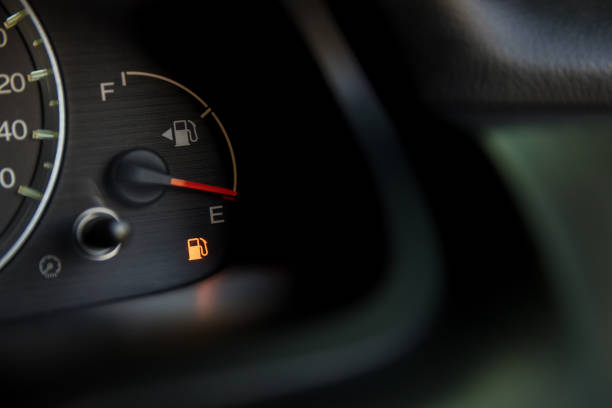 Empty fuel warning light in car dashboard. Fuel pump icon. gasoline gauge dash board in car with digital warning sign of run out of fuel turn on. Low level of fuel show on speedometer dashboard. stock photo