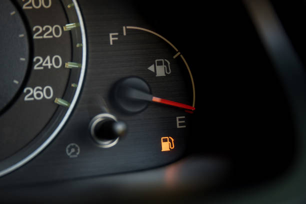 Empty fuel warning light in car dashboard. Fuel pump icon. gasoline gauge dash board in car with digital warning sign of run out of fuel turn on. Low level of fuel show on speedometer dashboard. stock photo