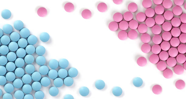 istock Blue and red pills isolated on white 1289001844