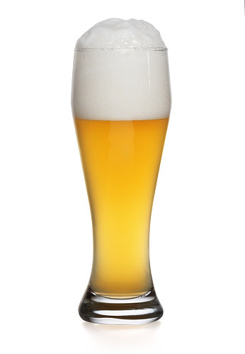 cold beer in glass on yellow background