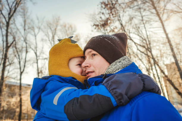 istock Father with his son in winter park 1289002438
