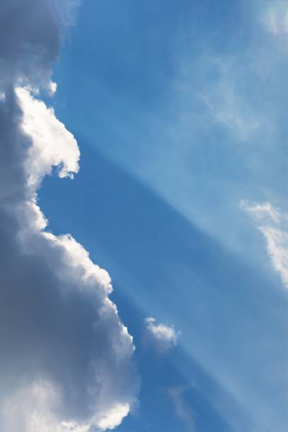 istock Beautiful white fluffy clouds on a sky background. Sunlight, light and shadow 1289002551