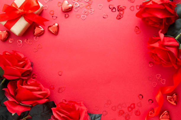 istock Valentine's day mock up, red roses, gift box and hearts on red background with copy space. 1289002756