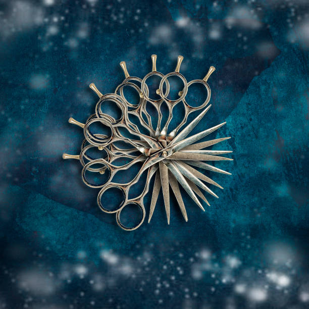 Barber scissors on a dark blue grunge background. Snow effect. New Year's greetings from the hairdresser. Festive background.