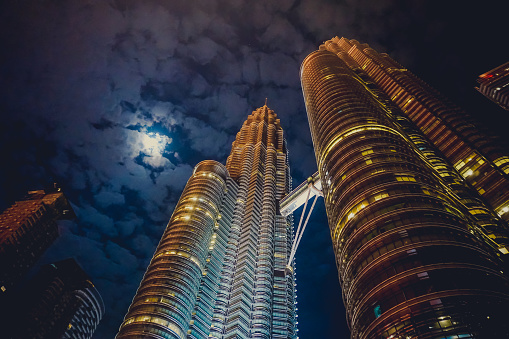 Petronas towers at night by moonlight