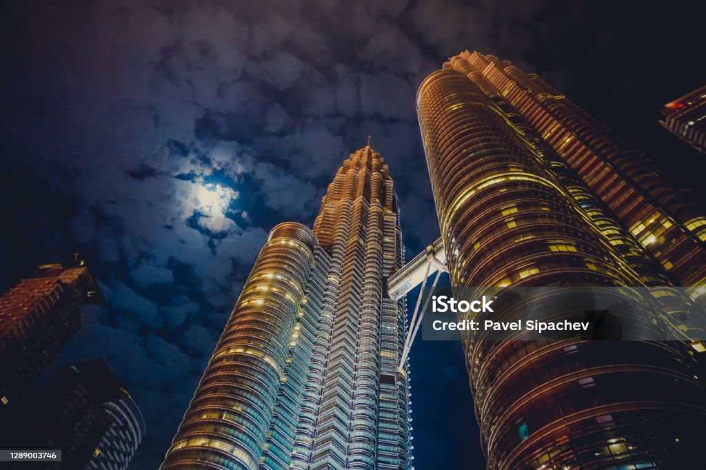 Petronas towers at night by moonlight Petronas Towers Stock Photo