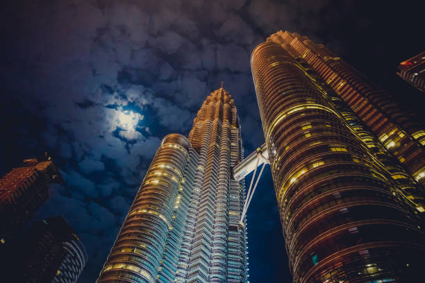 Petronas towers at night by moonlight Petronas towers at night by moonlight twin towers malaysia stock pictures, royalty-free photos & images