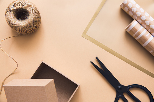 https://media.istockphoto.com/id/1289004225/photo/gift-wrapping-concept-wrapping-paper-rope-tape-and-scissors-on-beige-background-top-view.jpg?s=170667a&w=0&k=20&c=lJILFZQMnVrY6F6PeOacW_TWyxSA0AD7ZVVSAL2MItk=