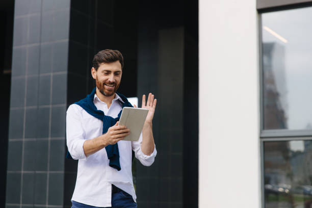 istock Businessman standing on street and talking during video call 1289004937
