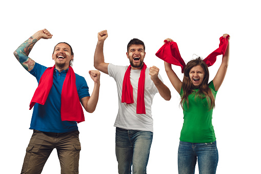 Excellent goal. Three soccer fans woman and men cheering for favourite sport team with bright emotions isolated on white studio background. Looking excited, supporting. Concept of sport, fun, support.