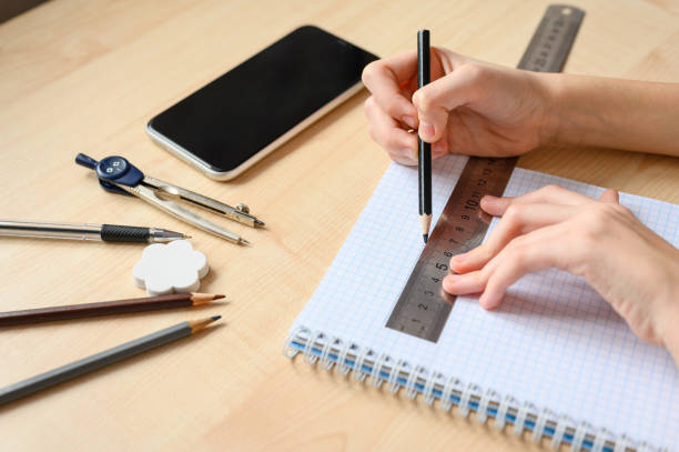 istock The student does his homework and draws a line with a ruler. 1289006418