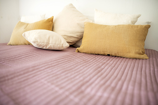 Germany: White and beige pillows lie on a bed.