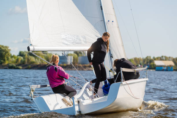 istock A fast, sporty, single-masted yacht with three athletes on board sails with a fair wind on a beautiful river 1289012892
