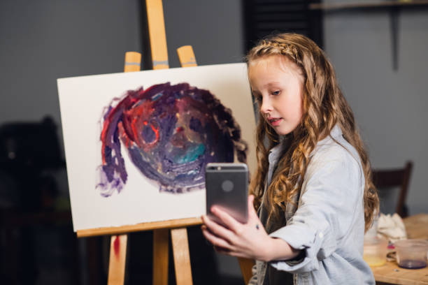 istock a young charming artist leads an online masterclass in drawing pictures in her workshop 1289013476