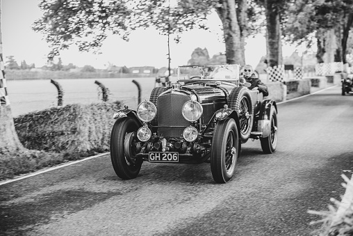 Bentley 6½ Litre driving on a country road. The Bentley 6½ Litre was a rolling chassis in production from 1926 to 1930. The car is doing a demonstration drive during the 2017 Classic Days event at Schloss Dyck.