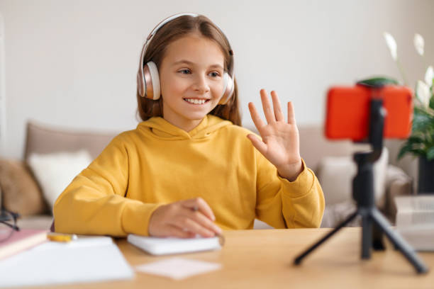 istock Happy girl learning from home via smartphone webcam 1289015121