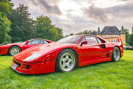 Ferrari F40 supercar of the 1980s at a classic car show. This red Ferrari is fitted with a bi-turbo V8 and was the former car of Formula 1 driver Nigel Mansell. The car is on display during the 2017 Classic Days event at Schloss Dyck.