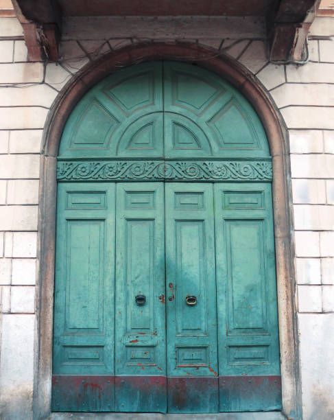 istock Old wooden door, gate in a stone wall. 1289015695