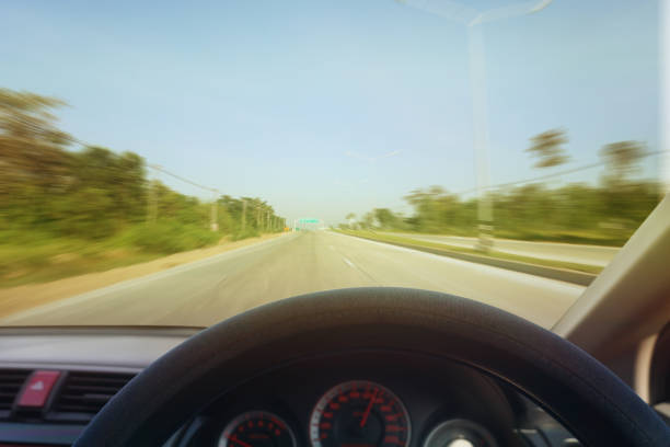 istock Dangers while driving on the road When there is light reflecting the sun on the front of the car Makes the road view unclear.Road safety concept 1289016741
