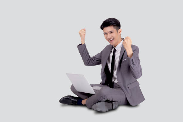 istock Young asian business man sitting work on laptop computer to internet online isolated on white background, businessman confident and notebook, freelance with success, marketing and communication. 1289016935