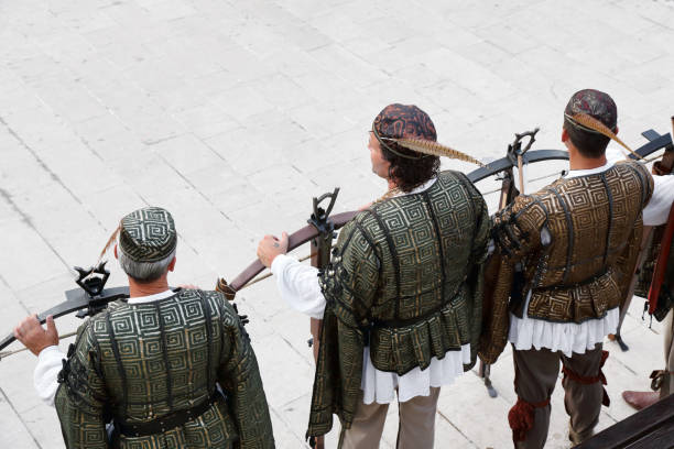 Rab, Сroatia - July 27, 2013: Crossbow Archers lined at the Rab Fjera. The days of the middle ages, “Rapska Fjera”, takes place on the St. Jacob's day, on St. Anna's day and on St. Christopher's day. The Kaldanac, The old town of Rab, is then transformed into a medieval town. Around 400 costumed citizens of Rab, members of various associations are showing the guests the medieval crafts and how people in the middle ages on the island were working, eating and celebrating. The programme lasts for three days and takes place in the evening hours.