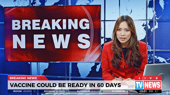 Female anchor presenting breaking news about new vaccine can be ready in next 60 days.