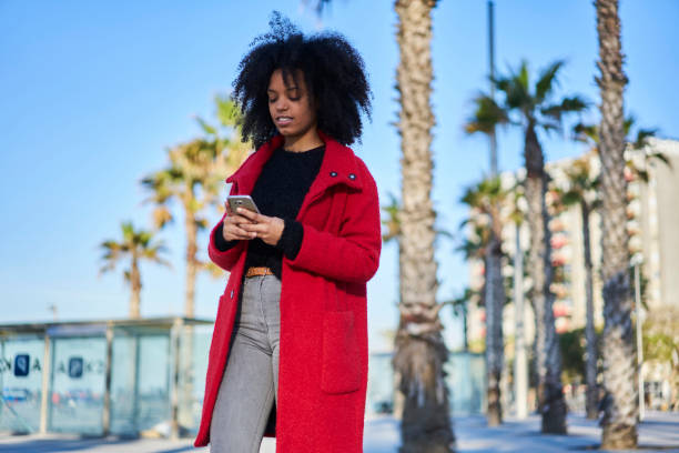 istock Confident black woman surfing smartphone 1289018366
