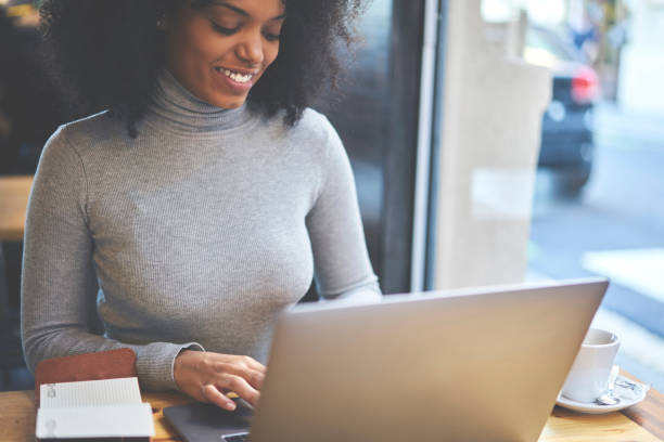istock Crop positive woman browsing laptop in cafe 1289018377